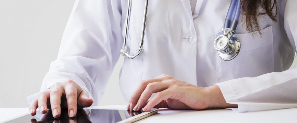 close-up-female-doctor-using-digital-tablet-medical-report-desk